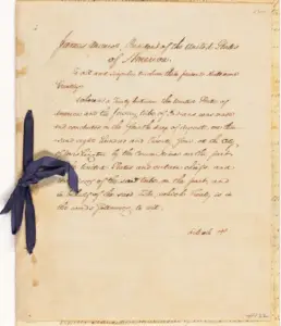 A historical document with handwritten text, signed by James Monroe, President of the United States, with a blue ribbon attached on the left side.