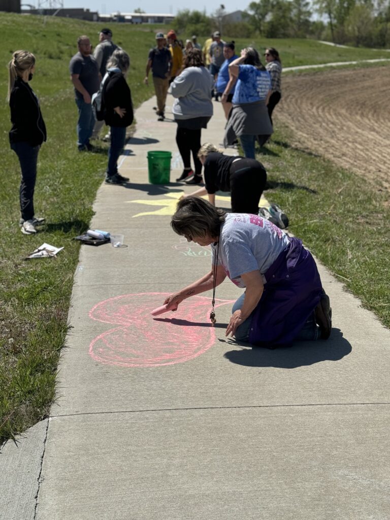 Themes were explored in sidewalk chalk. Eventually, there are plans to create a mural along the walking trail.
