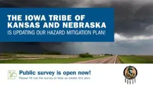 A stormy rural landscape with a dark, cloudy sky above a two-lane road and green fields. Overlaid on the image, a bold blue box reads, "The Iowa Tribe of Kansas and Nebraska is updating our Hazard Mitigation Plan!" Below the image, text on a white background reads, "Public survey is open now! Please fill out the survey to help us create this plan." The Iowa Tribe of Kansas and Nebraska logo appears in the lower right corner